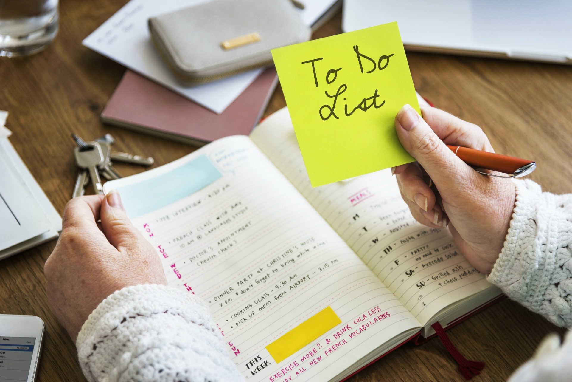 woman holding sticky note labeled To Do List