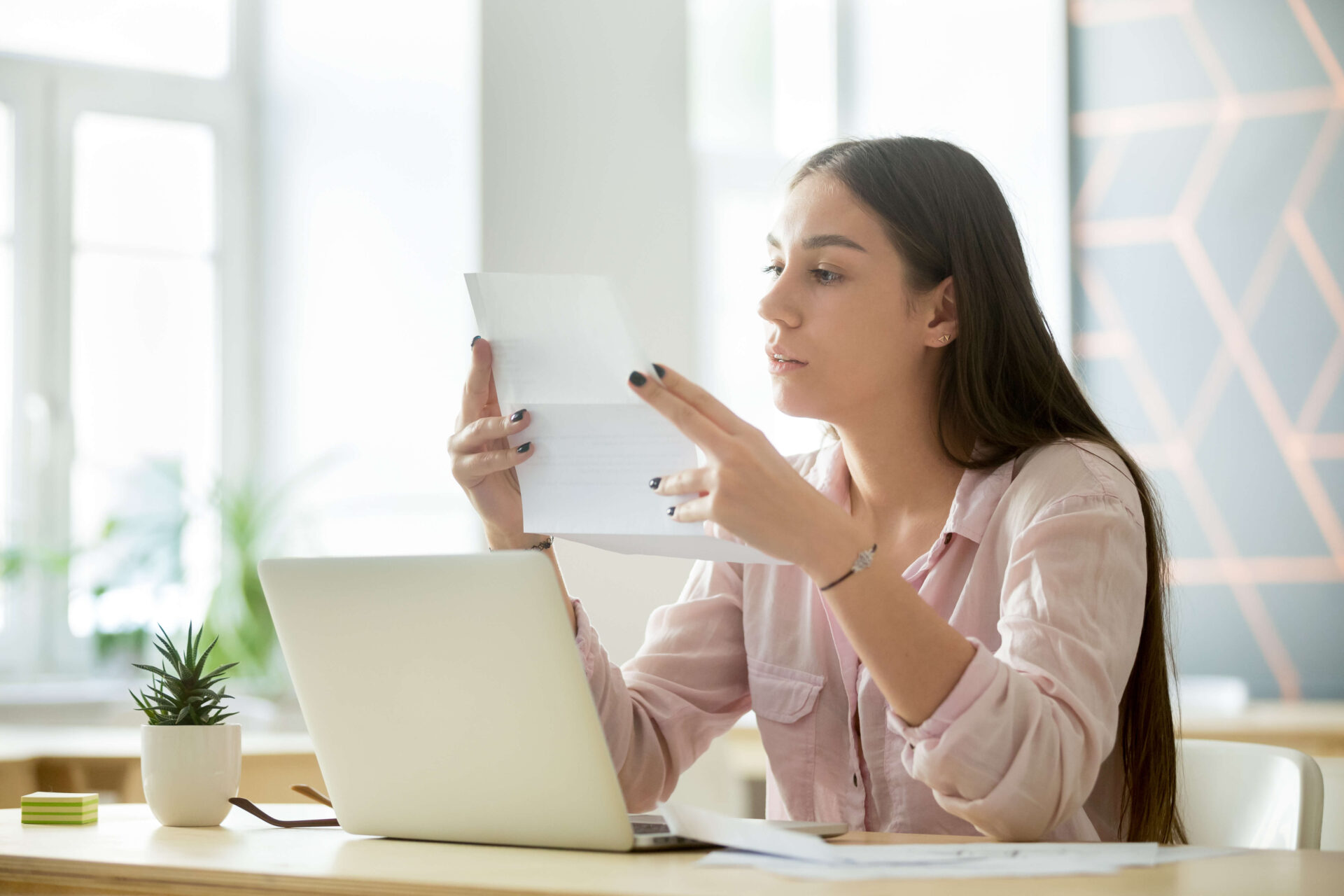 Woman reading from piece of paper