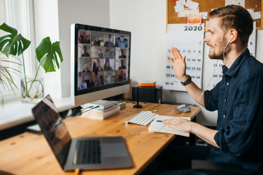 Young-man-having-Zoom-video-call-via-a-computer-in-the-home-office